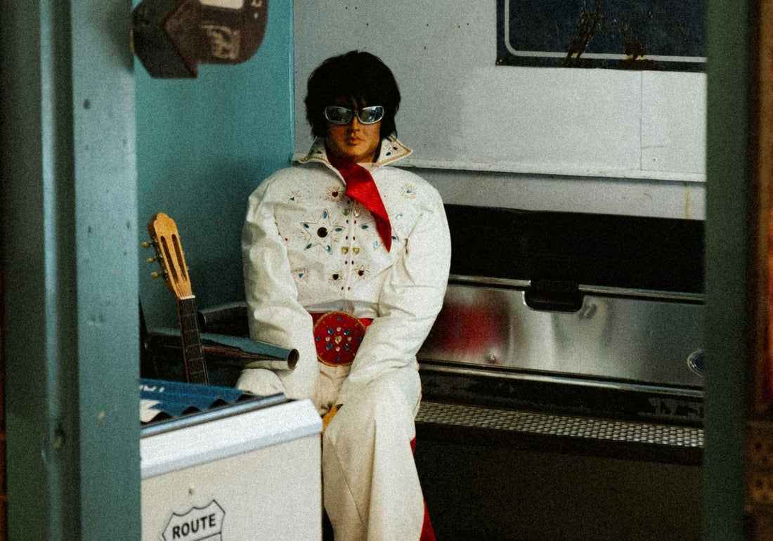 Someone dressed up as Elvis in 60s style clothing