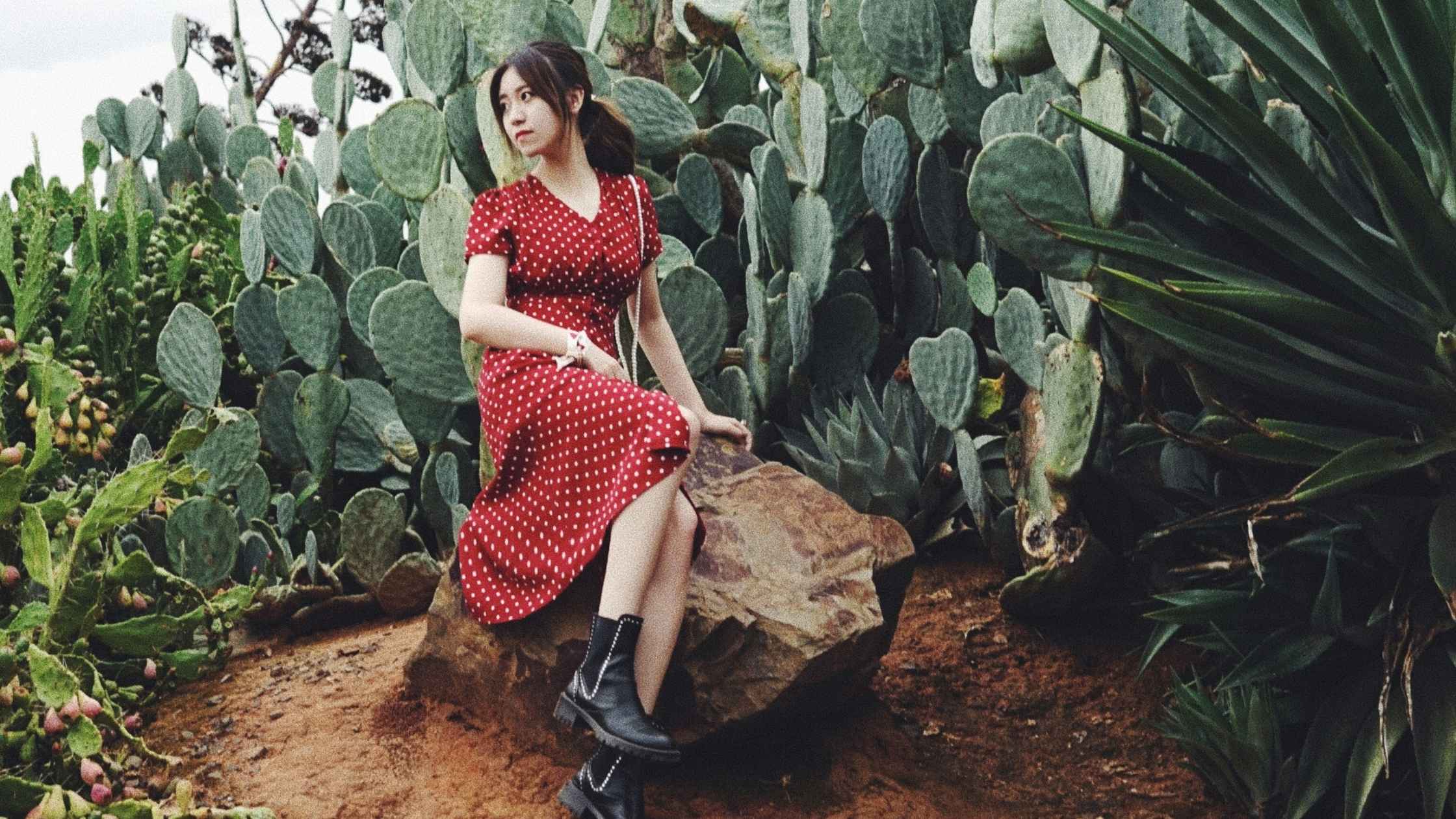 Woman wearing a red midi dress with black boots – dresses at Brag Vintage