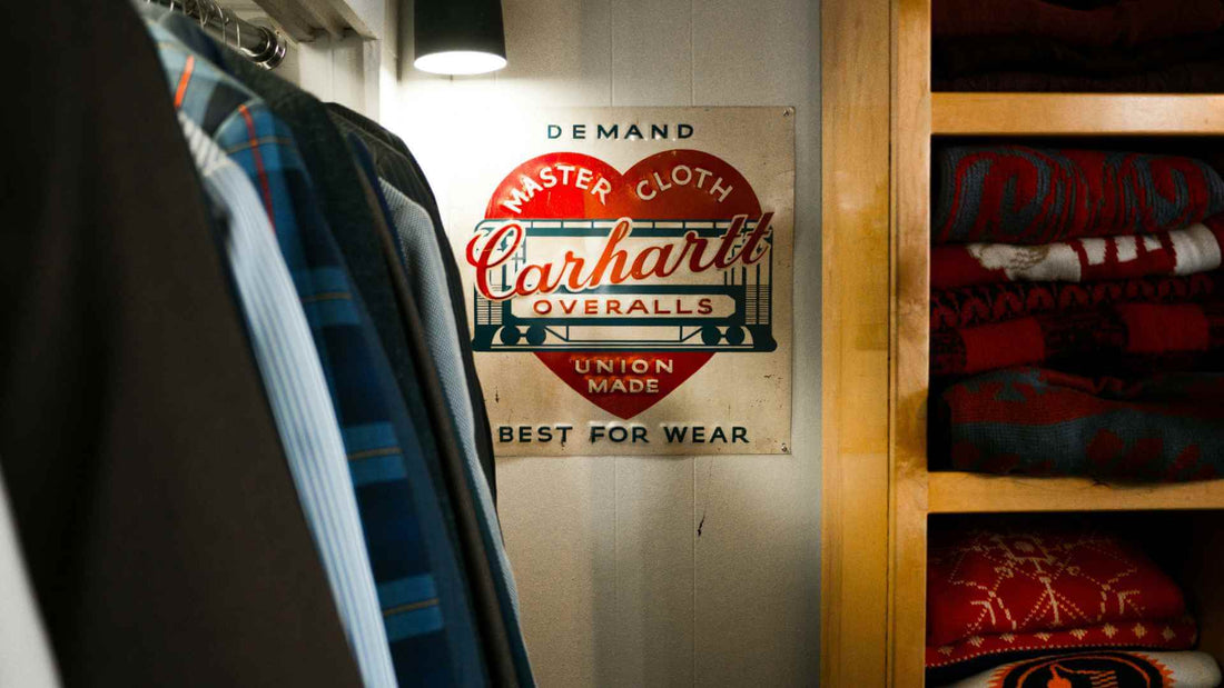The History of Carhartt featuring a carhartt poster on the wall in a vintage store