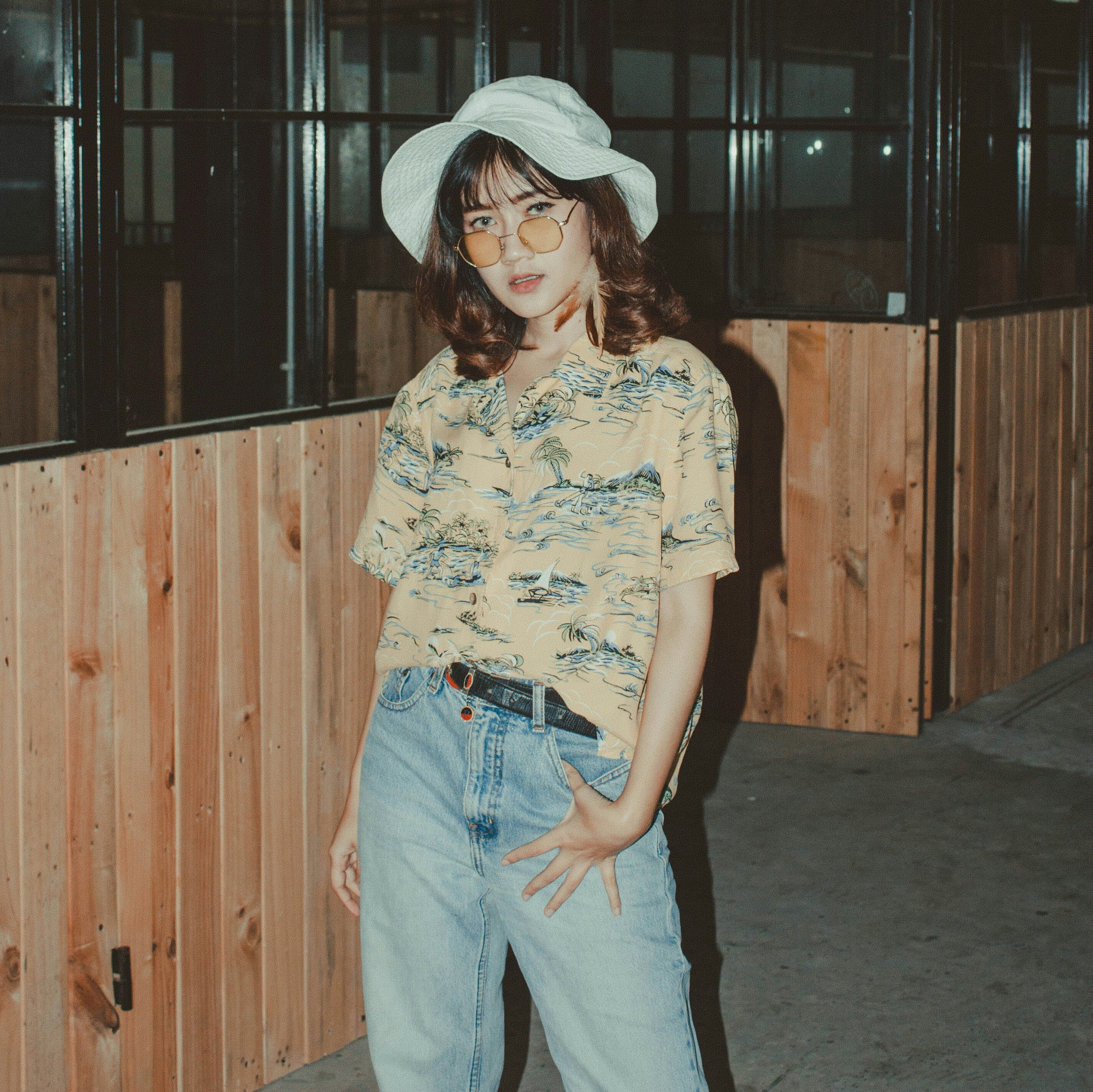 Vintage shirts for men & women featuring a women wearing a oversized vintage Hawaiian shirt