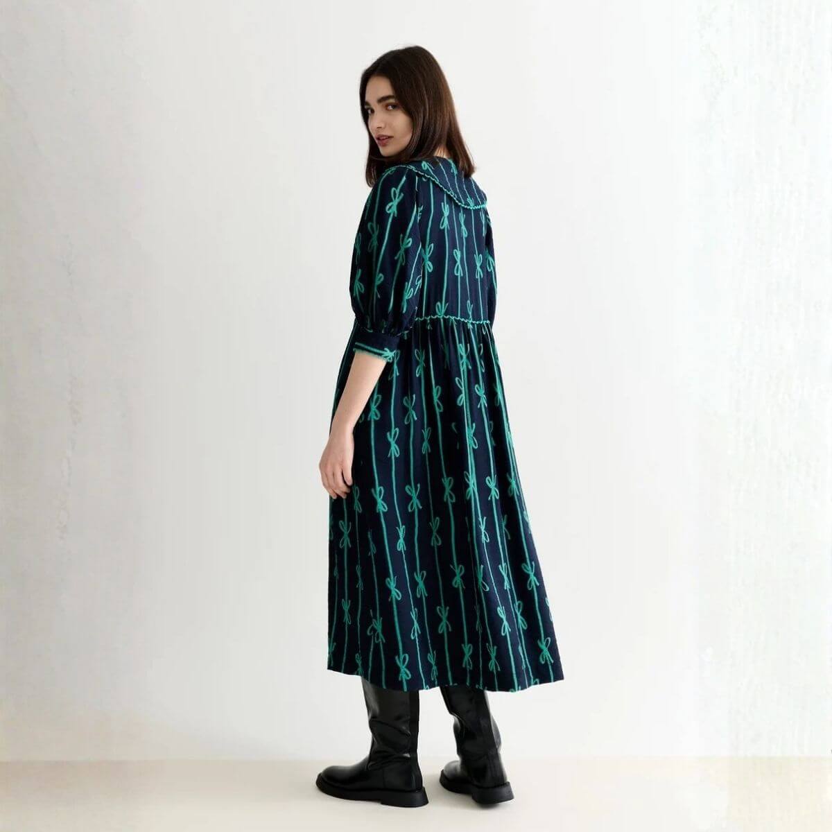 A model wearing a vintage style midi dress - Shop vintage-inspired and retro dresses at Brag Vintage