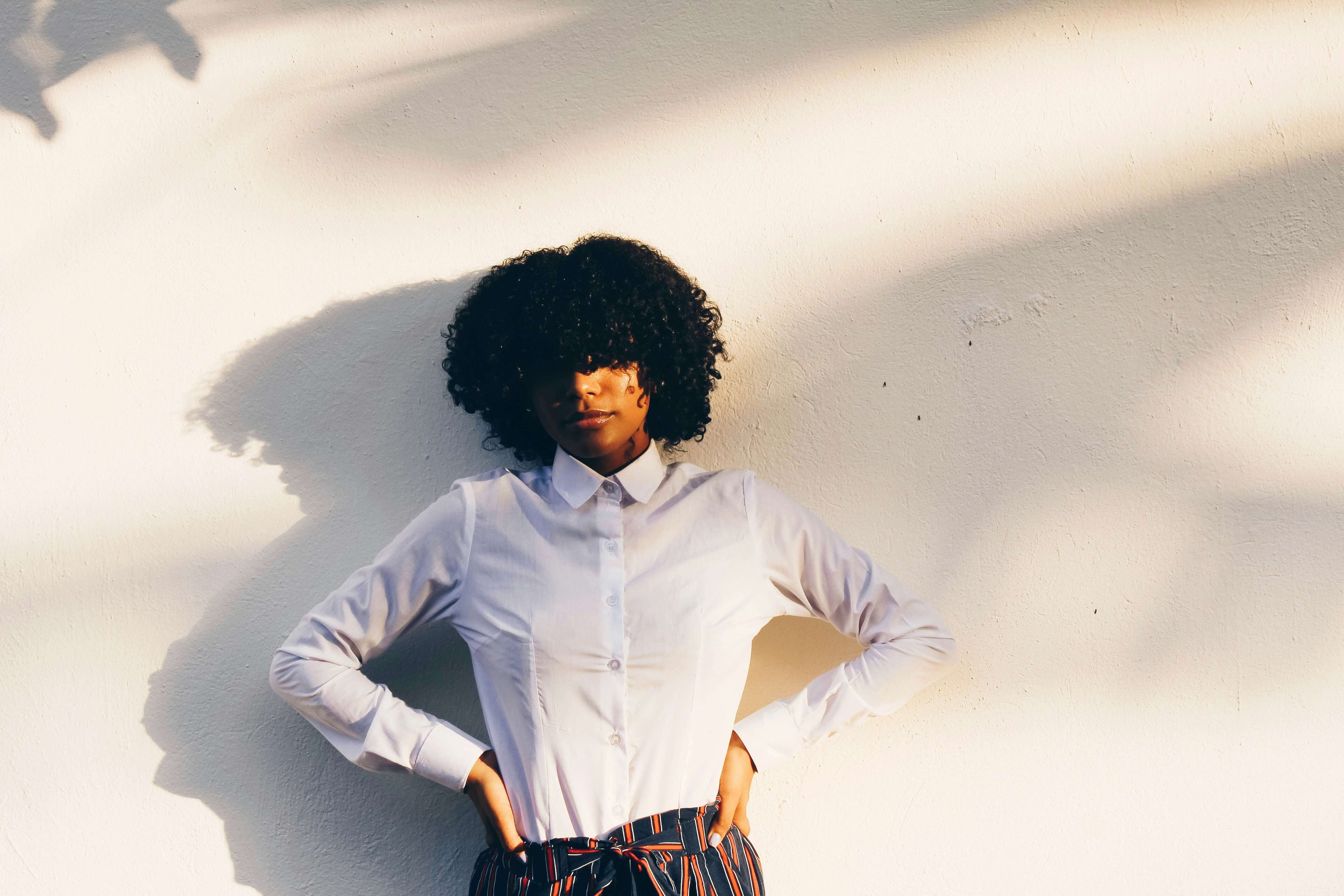 Woman wearing a simple plain blouse with patterned skirt for Women's New In - Shop all Women's Clothing at Brag Vintage
